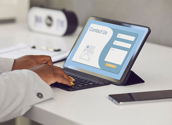 Person on a computer viewing a contact form on a dermatologist's website