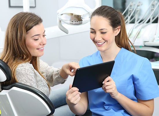 Dentist and patient and both are smiling