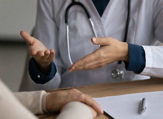 2 peoples hands with clear indication 1 is a doctor and is answering questions